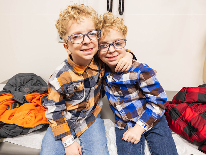 Twin brothers Travis, left, and Lucas Myrick of Ellisville smile during their visit to Children's of Mississippi's craniofacial clinic at the Kathy and Joe Sanderson Tower.